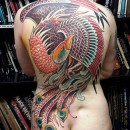 Back piece tattoo by Alex Binnie of large full colour phoenix in a traditional style