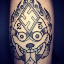 Tibetan skull tattoo with swastika on forehead and the number 23 on either side skull has its tongue out with the bottom of tongue another swastika and flames around skull