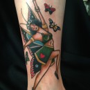 tattoo of woman with butterfly wings dancing with butterflies