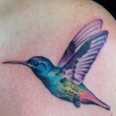 fine line watercolour style tattoo of hummingbird on shoulder