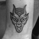 small tattoo of devils head with tongue out