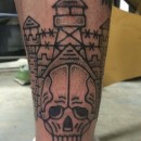 prison style tattoo of prison with watch towers and barbed wire with a skull in the foreground