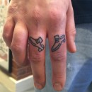 two fingers tattooed on top each one with one shoe to make a pair