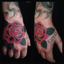 traditional English red rose on top of hand